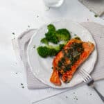 Herb Grilled Salmon (Olive Garden Copycat) with broccoli florets on a plate.