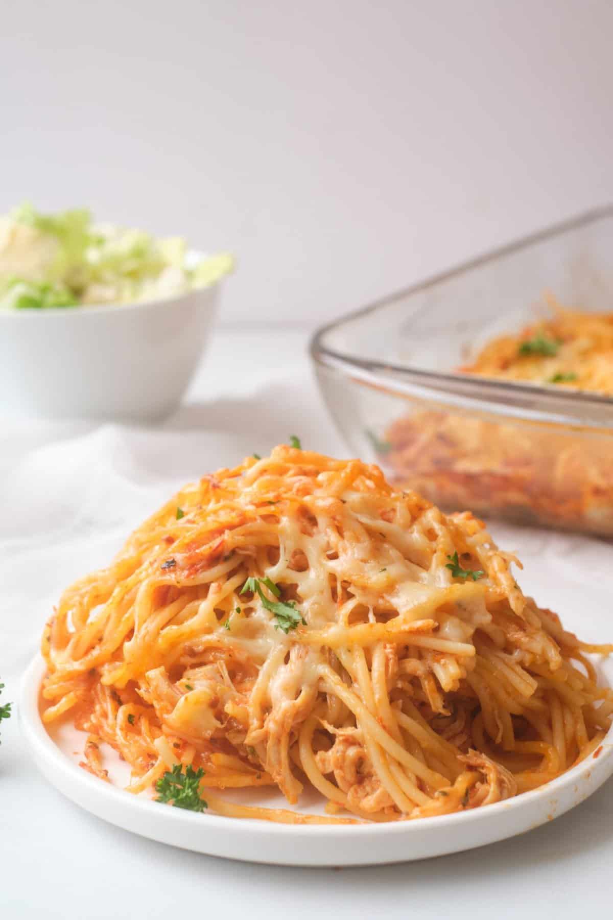 Chicken parmesan spaghetti bake on white plate