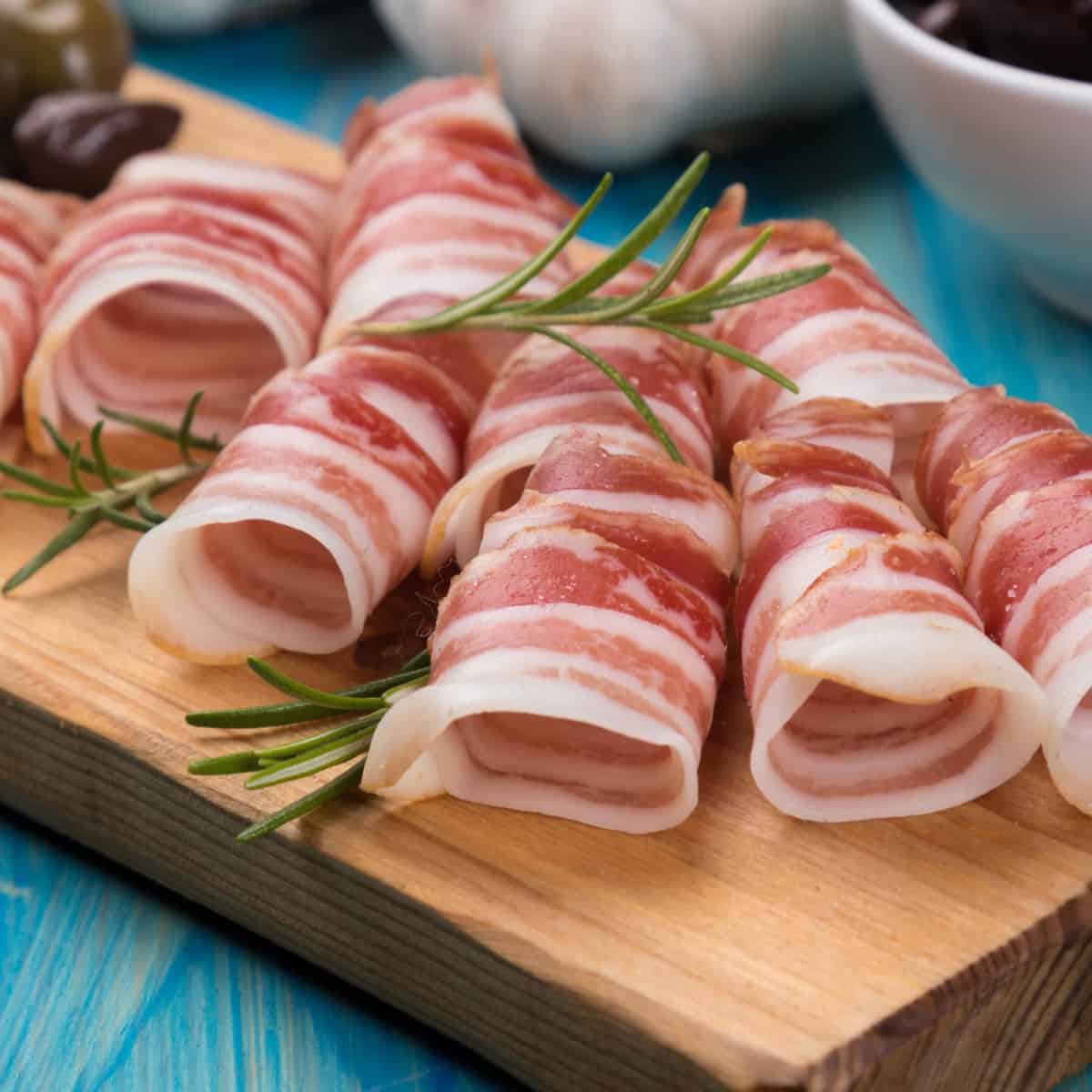 Rolled Pancetta on Cutting Board