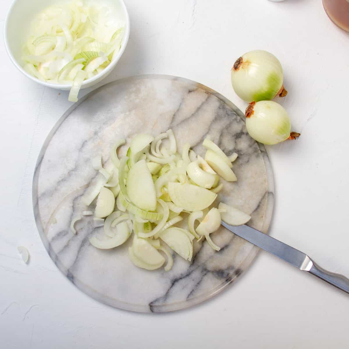 Sliced onions on a cutting board. 