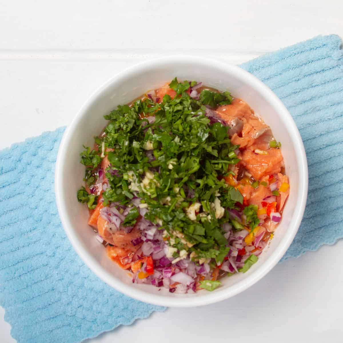 Chunks of fresh salmon topped with diced red onion, garlic, cilantro, and fresh chilis. 