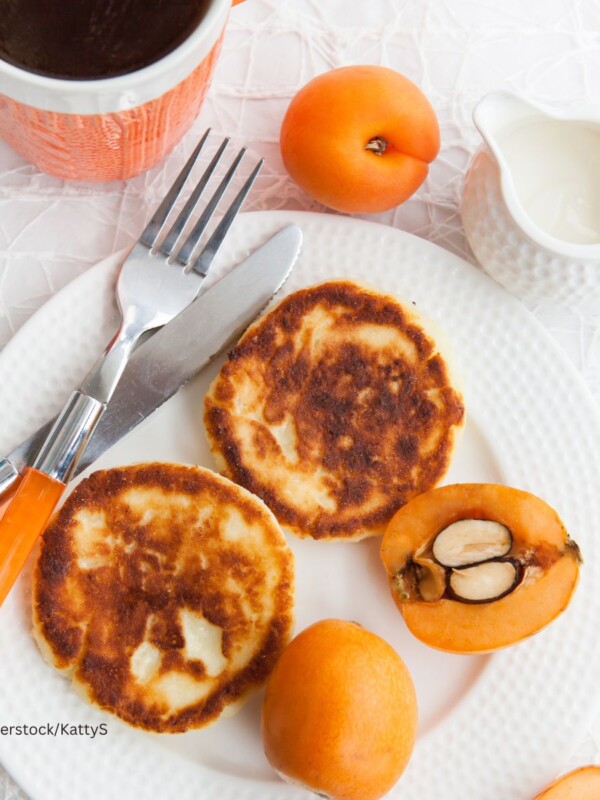 Sliced loquat on white plate with cottage cheese pancakes