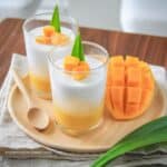 taro pearls with mango pudding in a dessert glass on a wooden serving platter