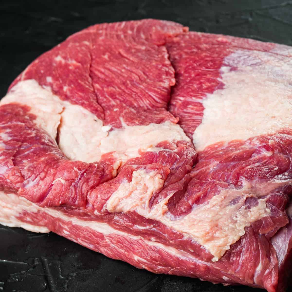 Brisket flat cut, raw beef brisket meat set, on black stone background