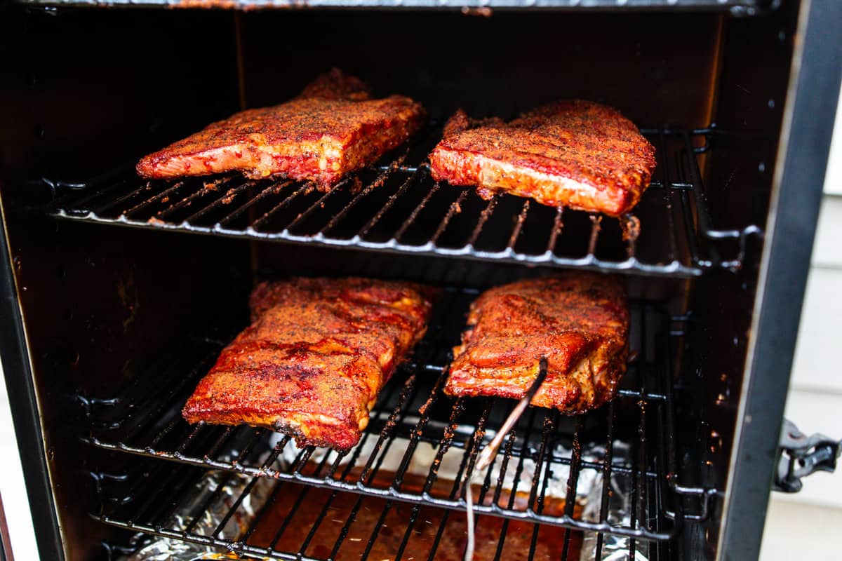 cooked spare ribs inside vertical pit boss smoker