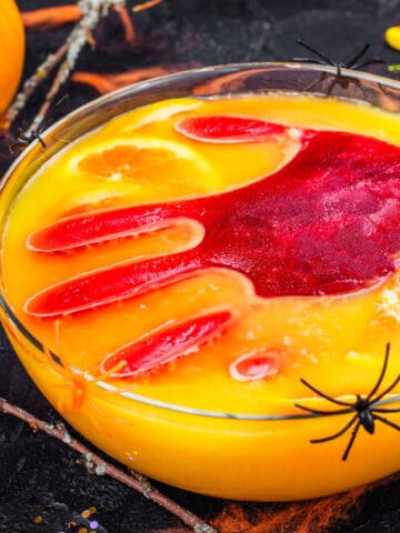 Scary halloween punch with red hand print in orange punch