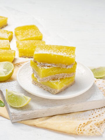 Delicious, lightened-up lemon bars stacked on a plate.