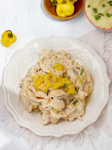 Shredded Mississippi Chicken garnished with yellow pepper.