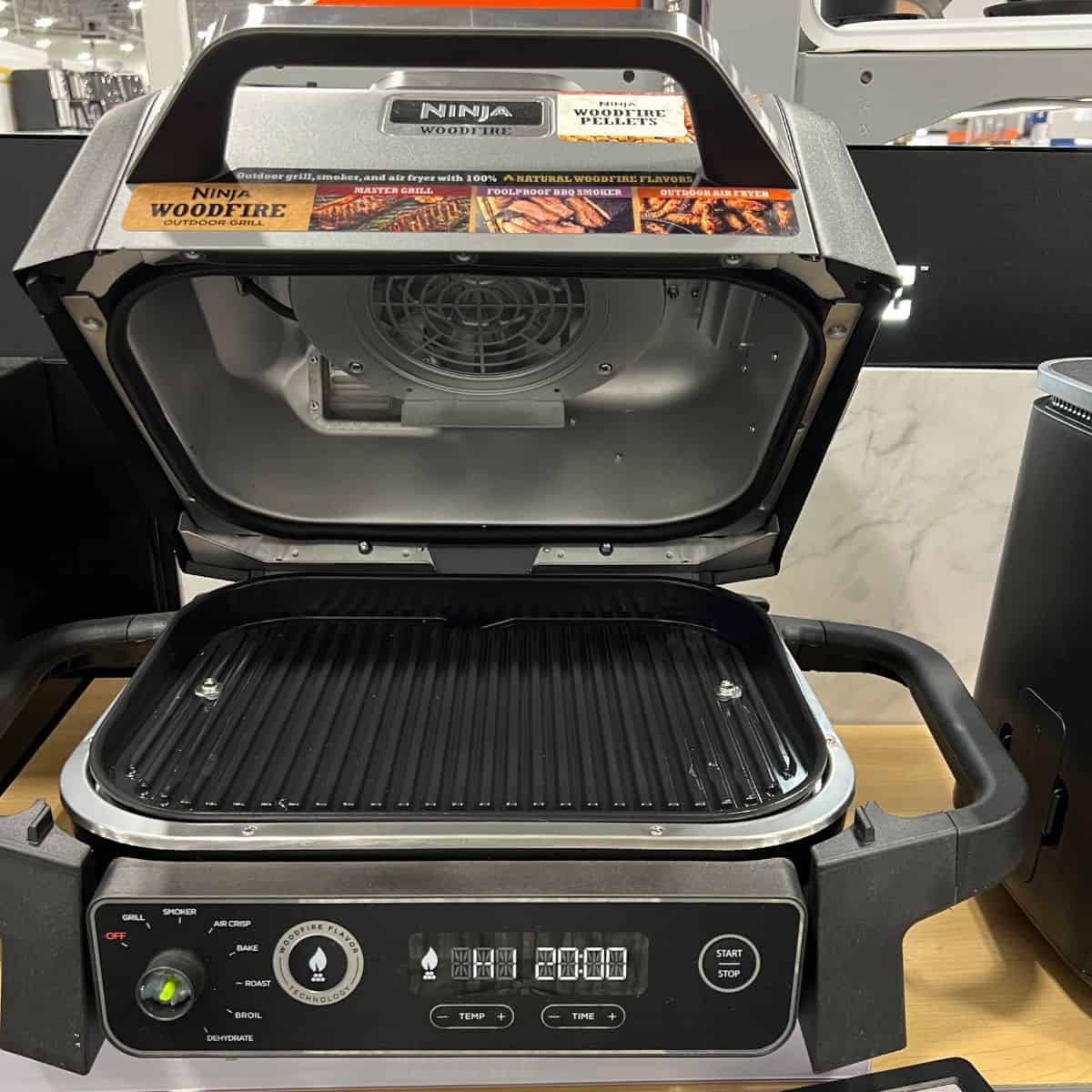 ninja woodfire grill with top up showing the grilling surface