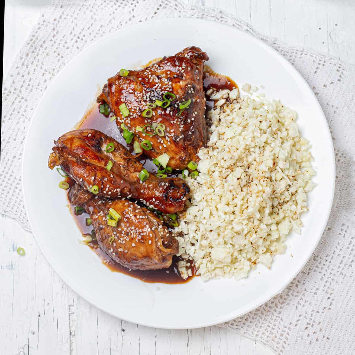 Sweet and sour Shoyu chicken and rice on a plate.