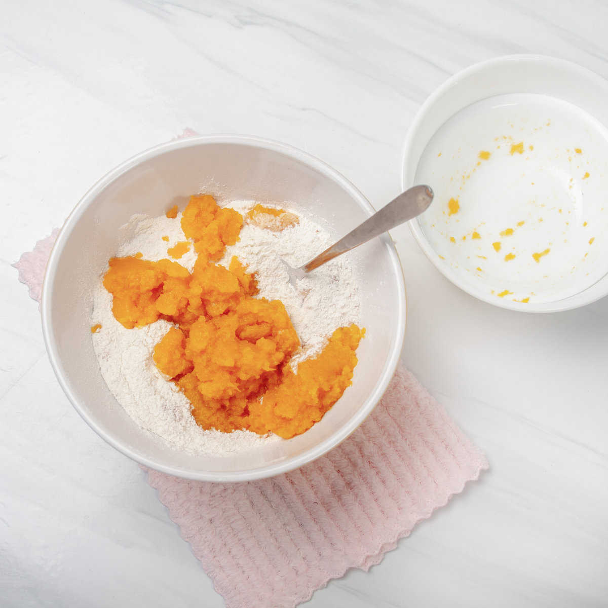 Pumpkin cake mix and pumpkin puree combined in a bowl. 