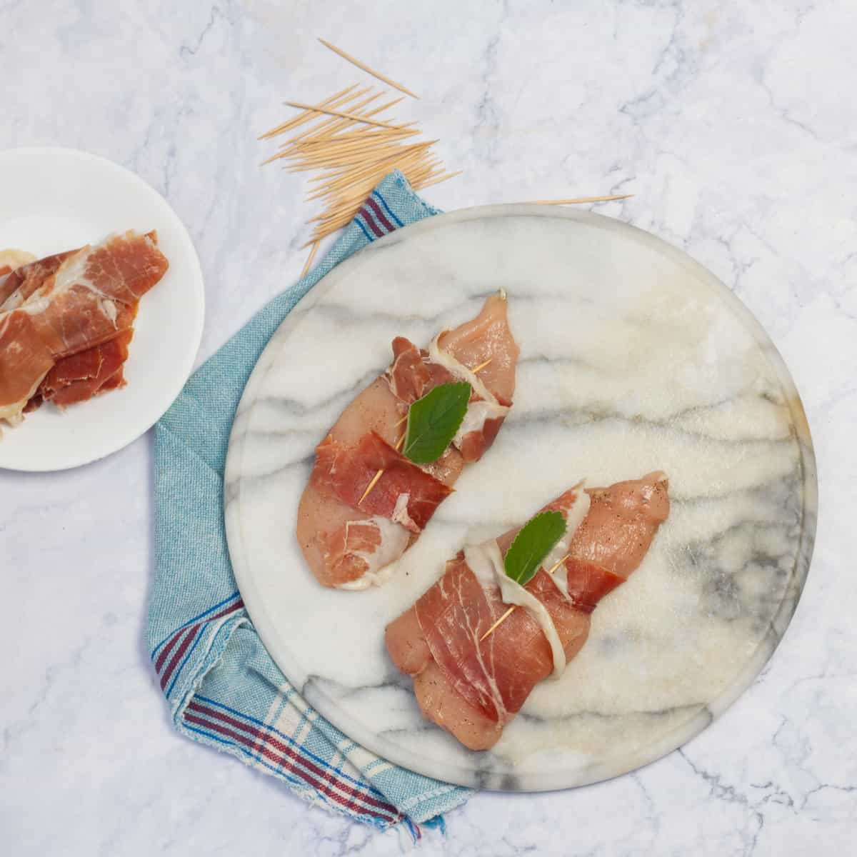 Seasoned raw chicken wrapped with prosciutto. 