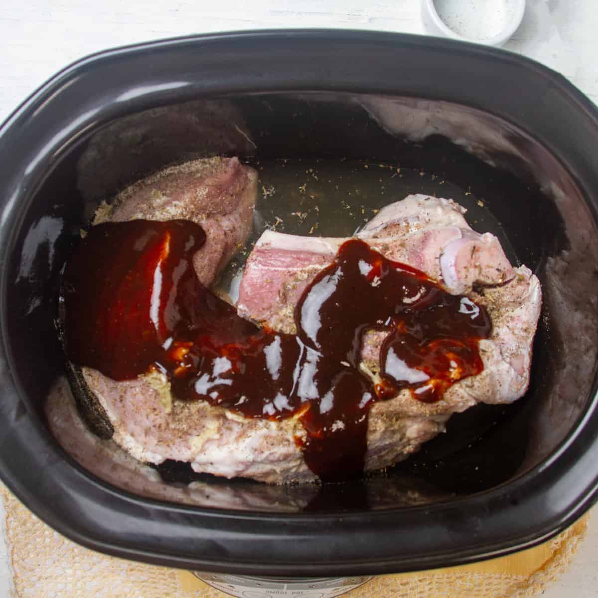 Coat the meat with a mixture of BBQ sauce, vinegar, and chicken broth.