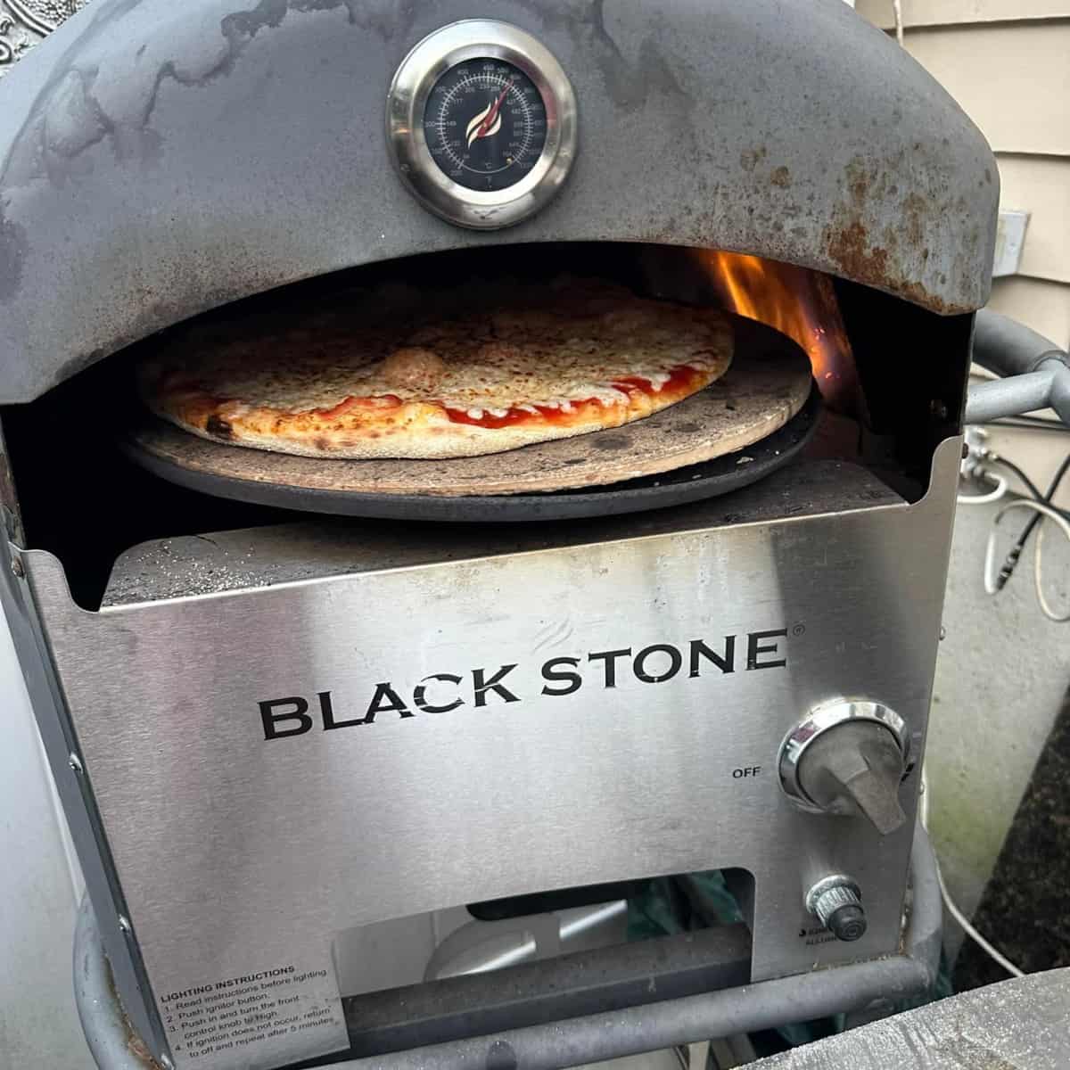 blackstone pizza oven cooking a pizza