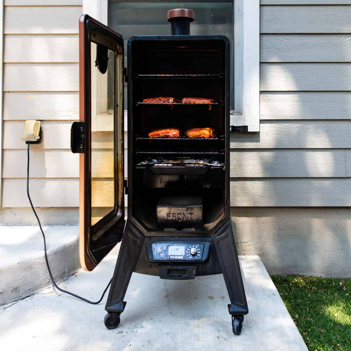 upright smokers with ribs cooking