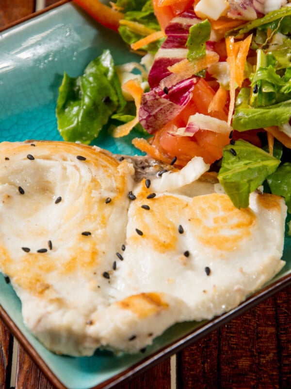 grilled wahoo with salad on a plate