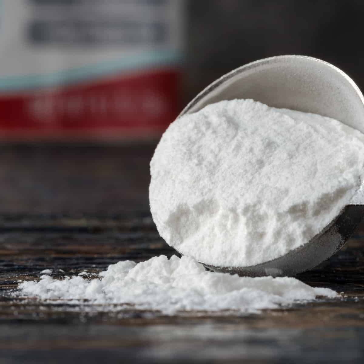 Baking powder spilling out onto dark counter top