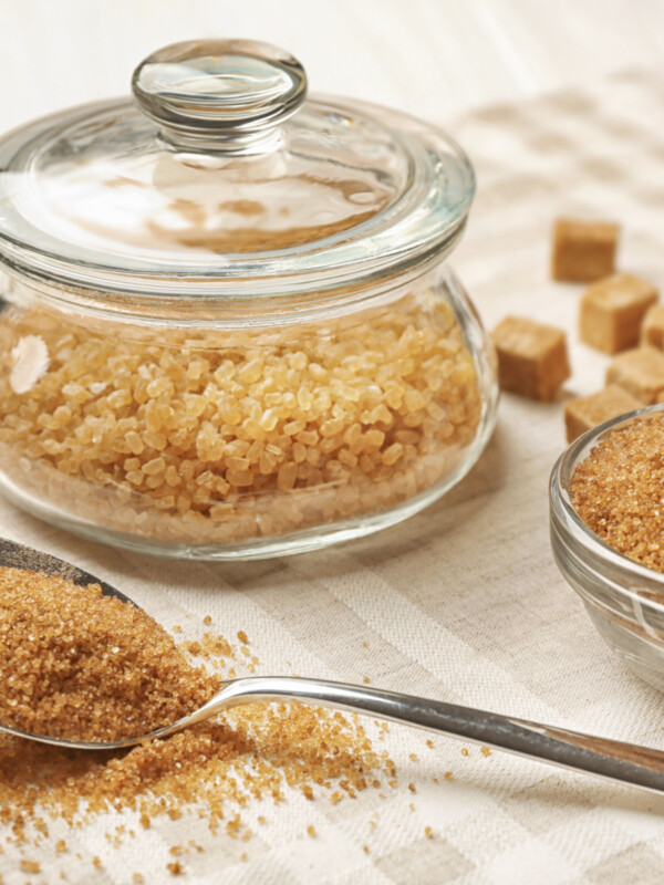 brown sugar container next to brown sugar on teaspoon