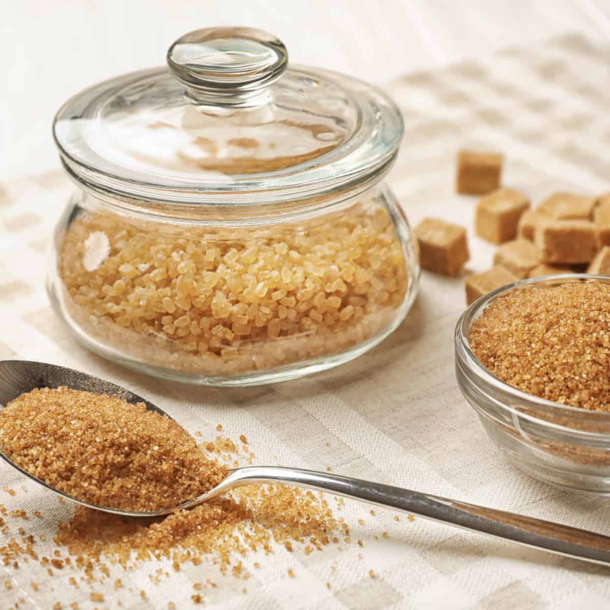 brown sugar container next to brown sugar on teaspoon