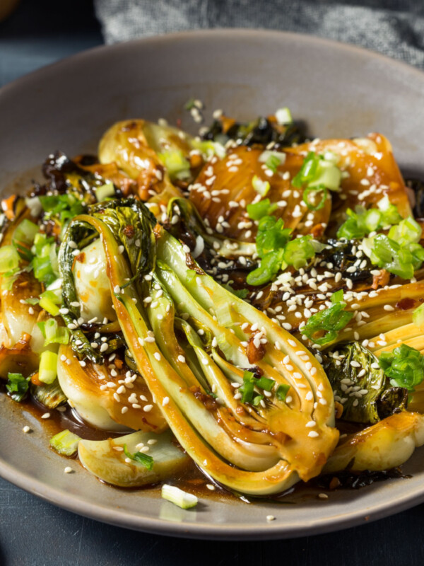 Asian style roast bok choy on beige plate.