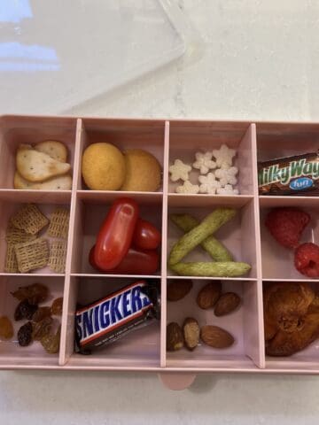 snackle box filled with snacks on white counter top