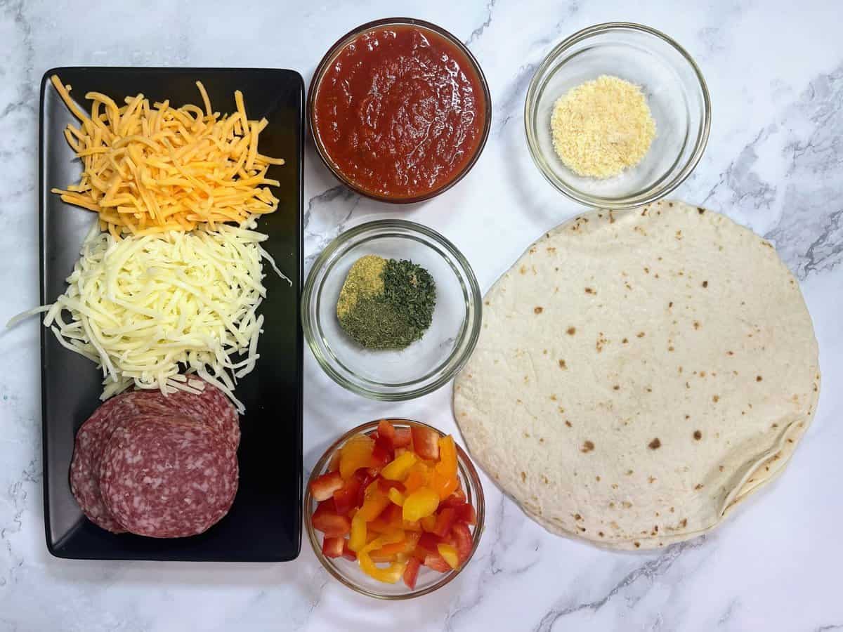 pizza burrito ingredients laid out on counter