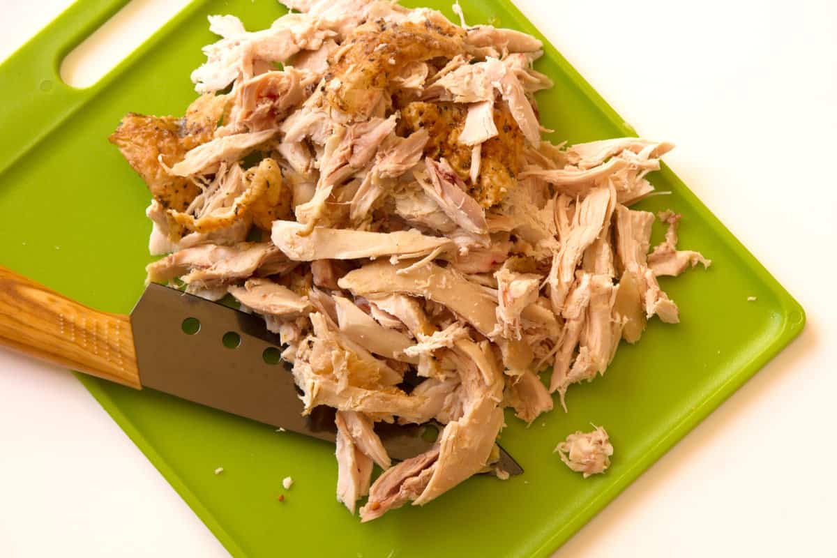 Shredded chicken on a cutting board 