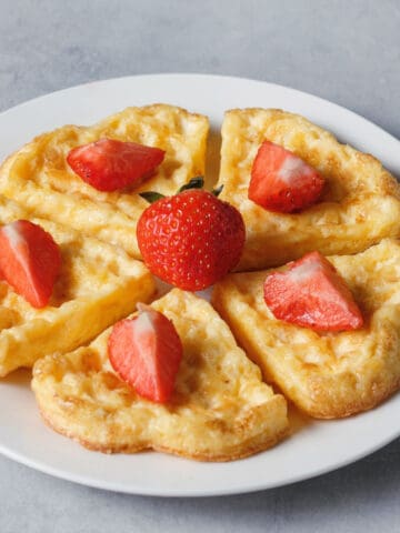 chaffle topped with strawberries on a white plate
