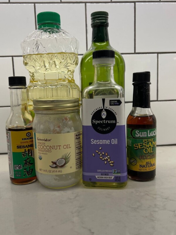 various cooking oils sitting on white counter