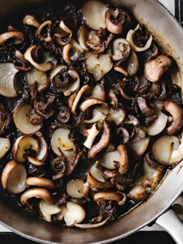 mushrooms and onions sauteeing in pan