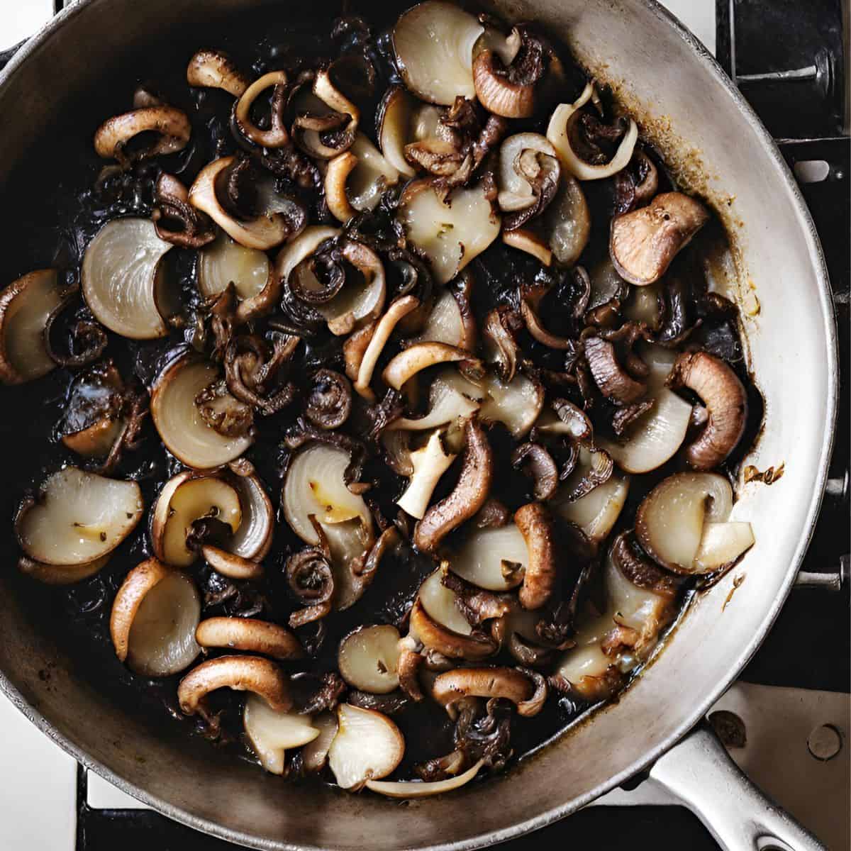 mushrooms and onions sauteeing in pan