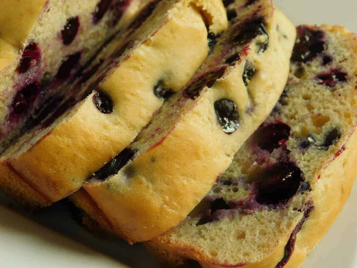 blueberry lemon loaf sliced on cutting board