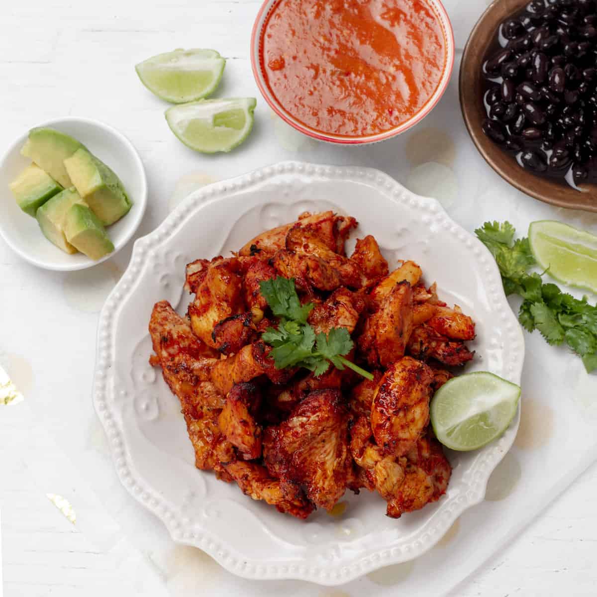 Chicken al Pastor served with cilantro topping and lemon slice