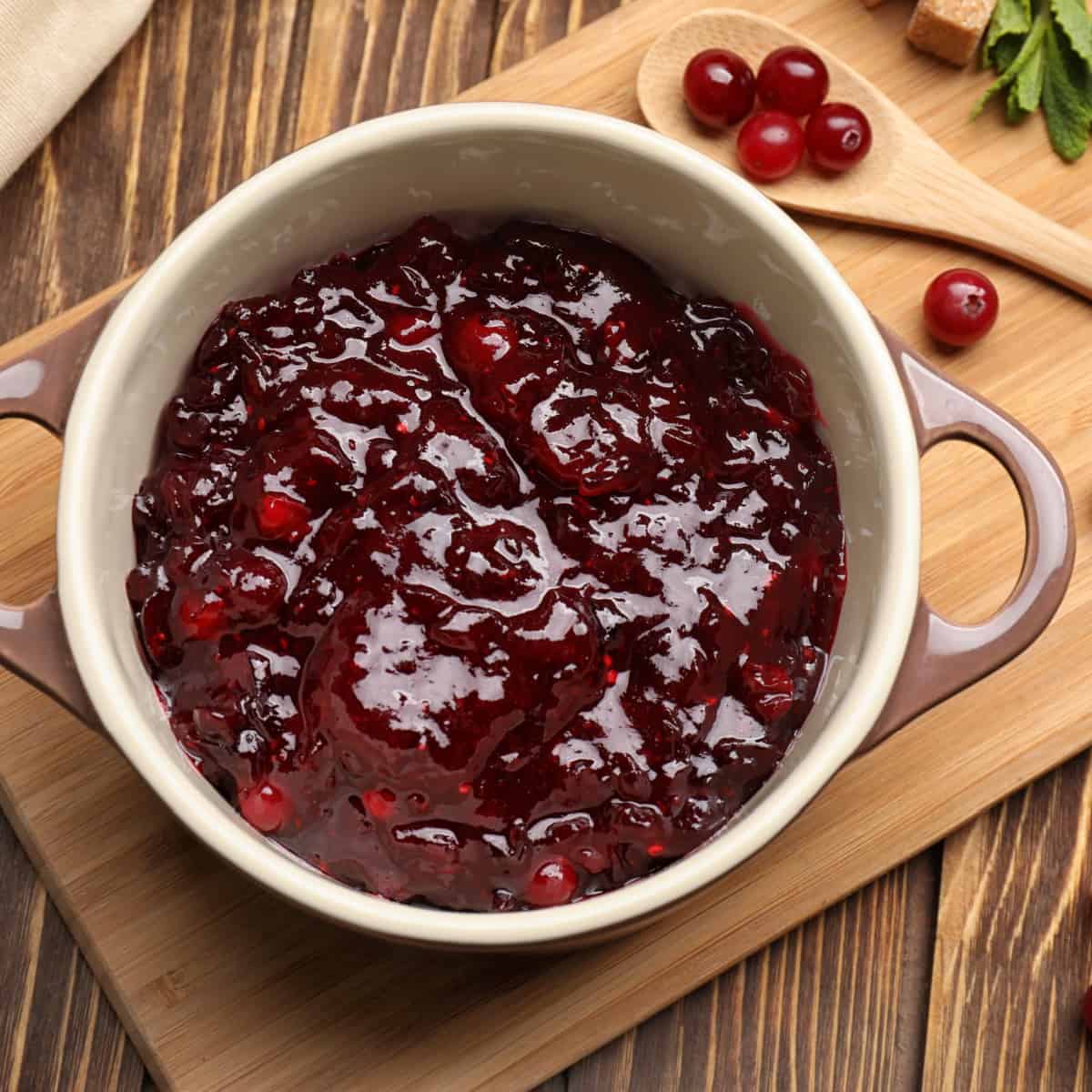 cranberry sauce on wooden cutting board
