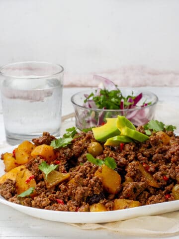 Cuban Picadillo served with salad and dressing of Avocados slices