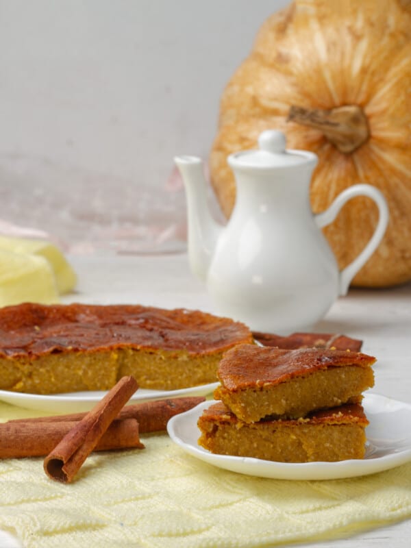 Pumpkin Cake displayed with pumpkin, cinnamon sticks and tea pot