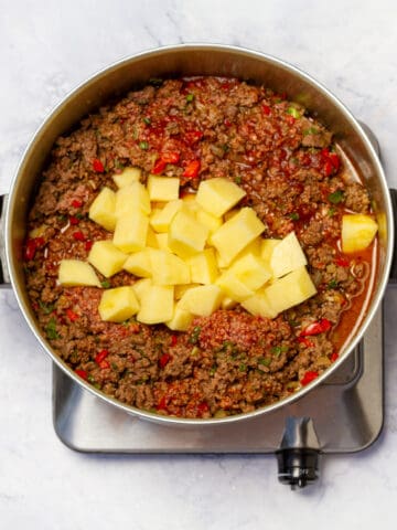 Added potatoes to Cuban Picadillo in large skillet