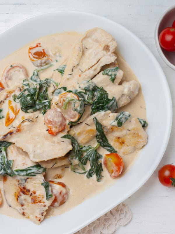 Creamy Weight Watchers Tuscan Chicken with spinach and cherry tomatoes.