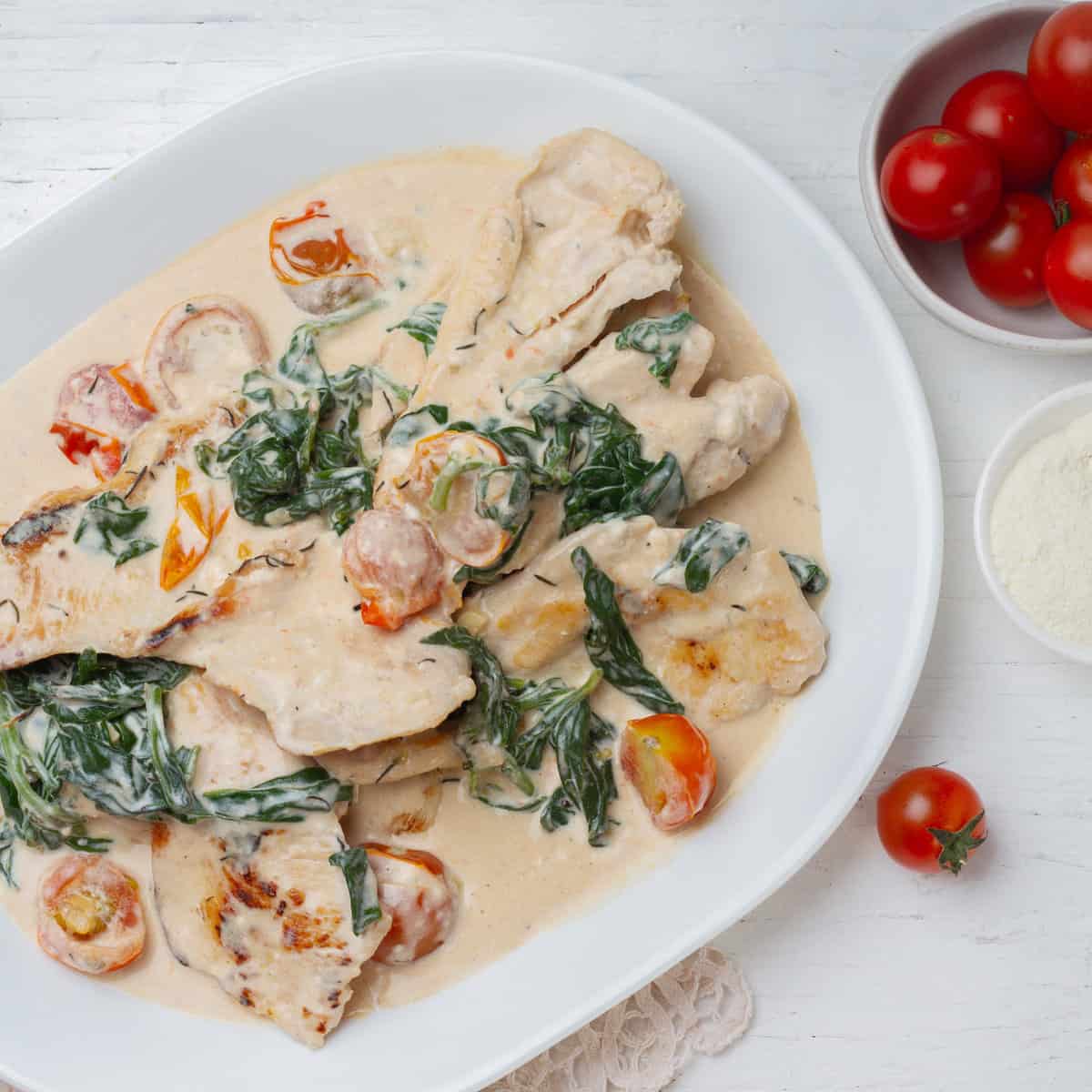 Creamy Weight Watchers Tuscan Chicken with spinach and cherry tomatoes.