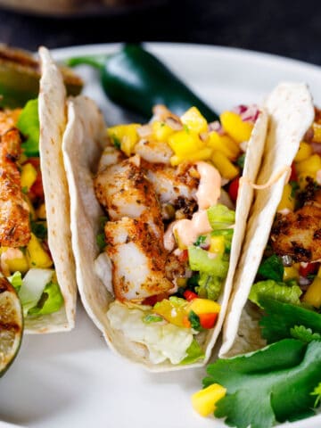 Fish tacos on white plate