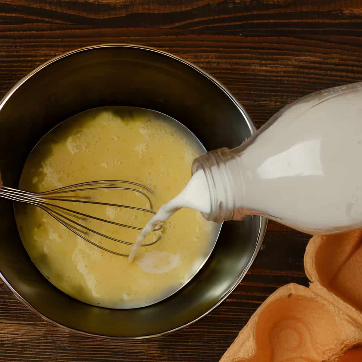 milk pouring into egg mixture