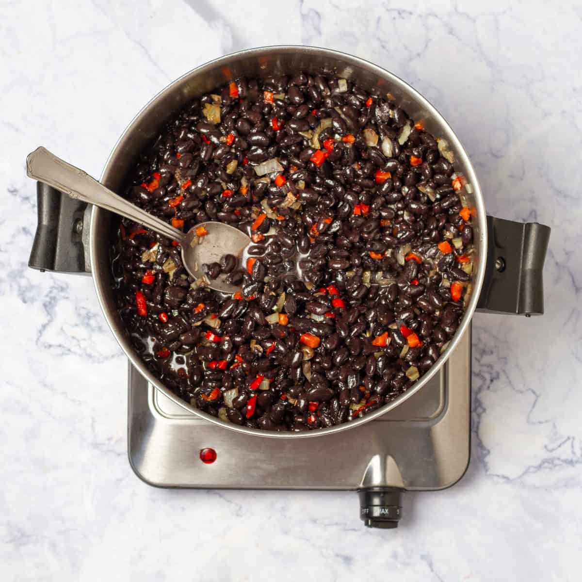 Black Bean Soup ingredients cooking in a pan on medium flame