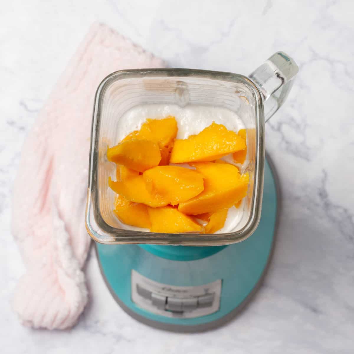 Creamy Mango and Coconut Ice Cream ingredients in a blender