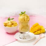 Creamy Mango and Coconut Ice Cream served in a bowl and glass with mango