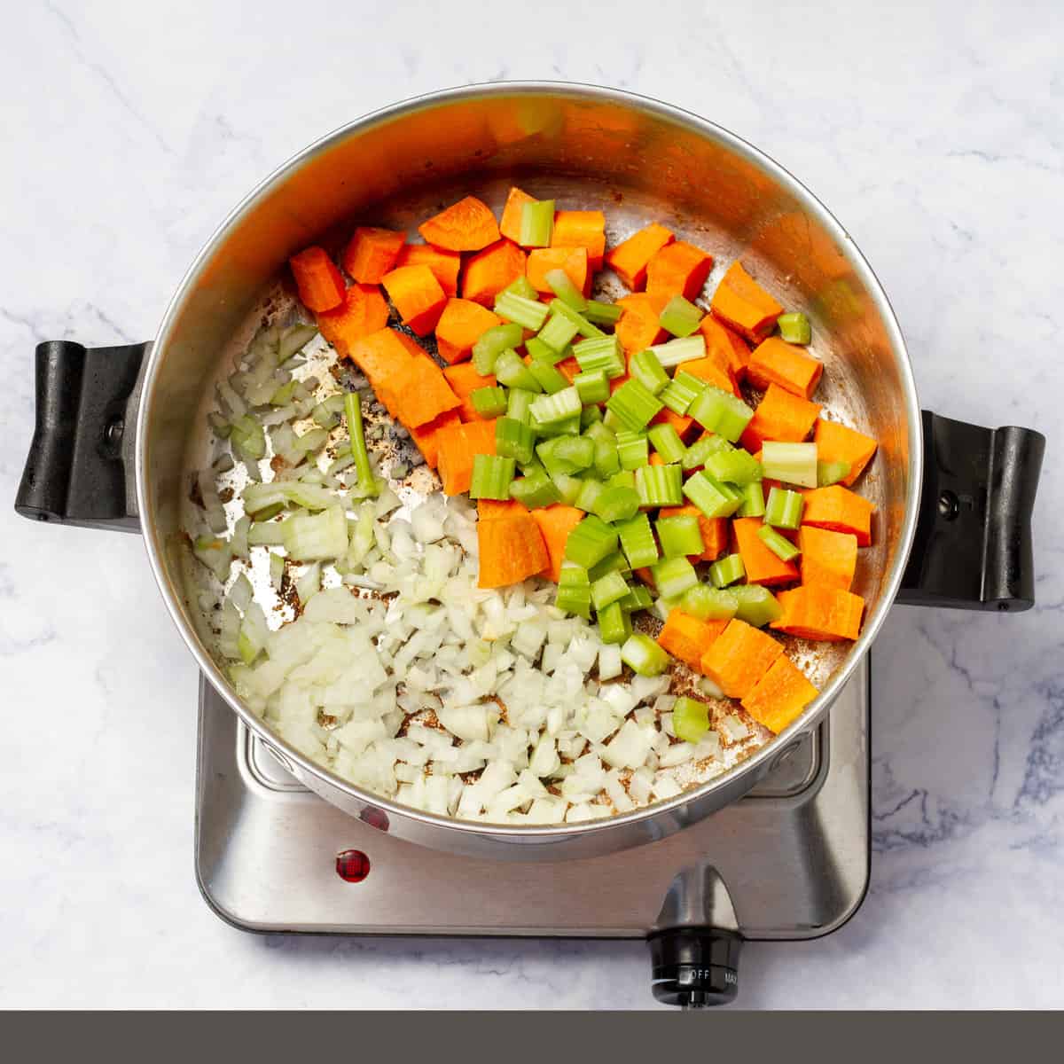 zucchini, carrots, beef, and onions in sauce pan