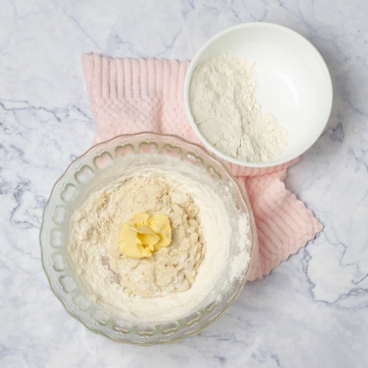 Combine the active dry yeast with cup warm water in a small bowl. In a separate bowl, cut the butter into the flour.