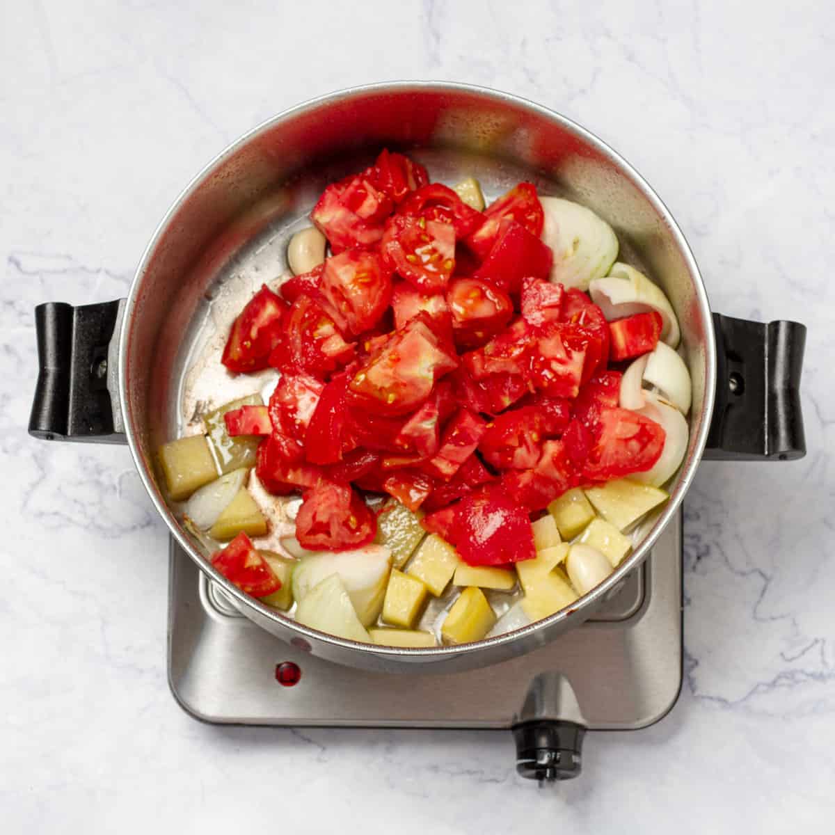diced tomatoes and peeled potato added to cooked Onion and Garlic in sauce pan