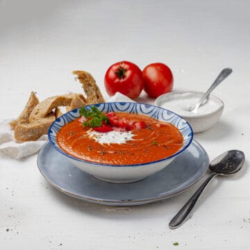 Tomato Soup served in a bowl with tomatoes at display