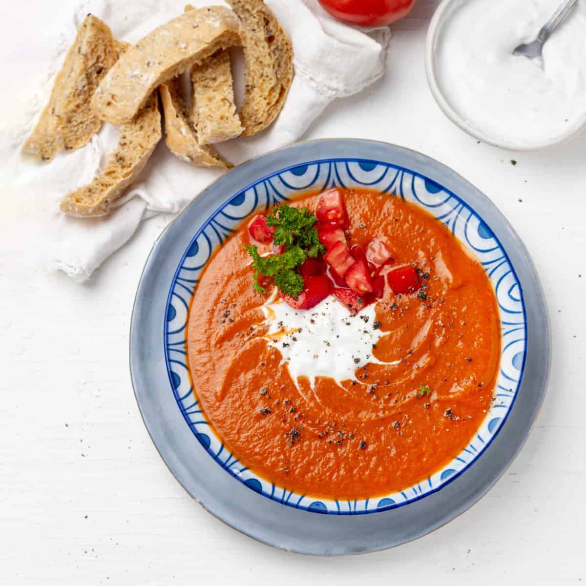 Tomato Soup served in a bowl with tomatoes at display