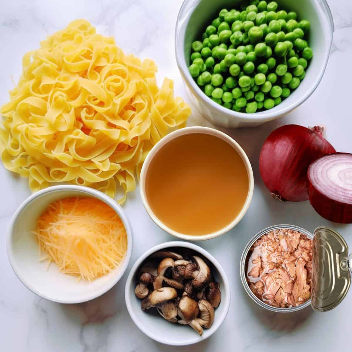 ingredients for tuna casserole on white cutting board